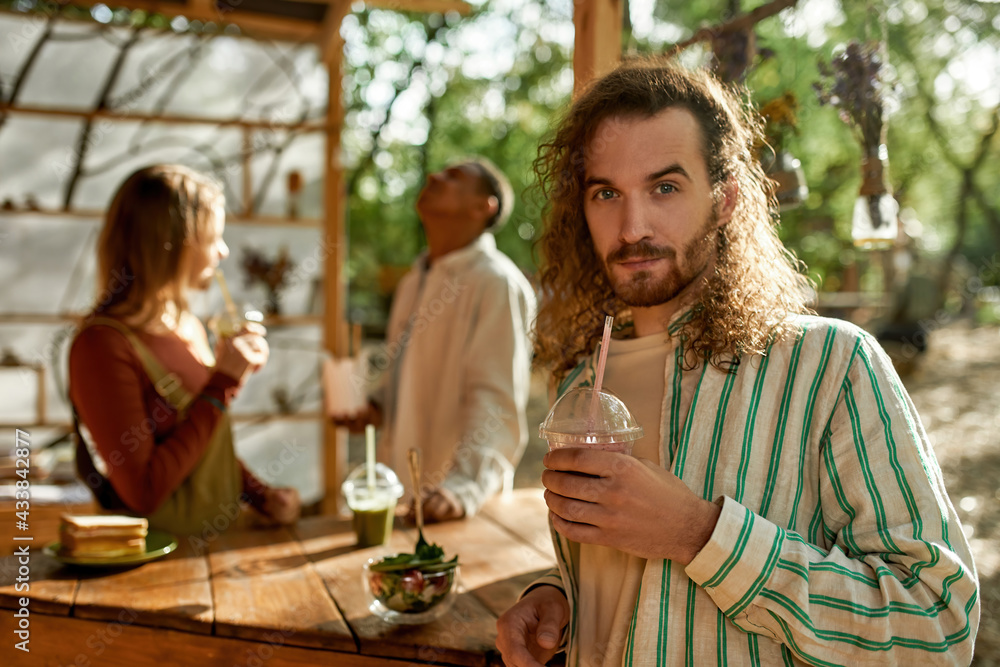 Portrait of young caucasian man drinking juice Portrait of young caucasian man drinking juice