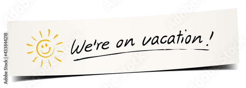  Paper banner with handwritten message and little sun icon - We're on vacation