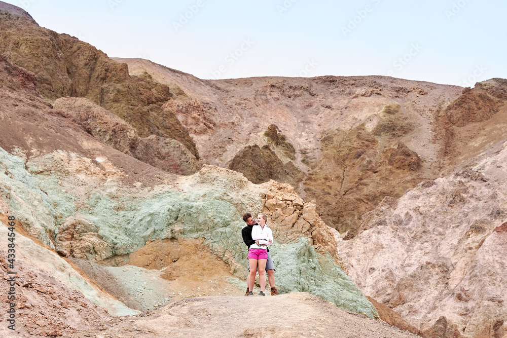 A family with a teenage girl is hiking Dante’s View trail in Death Valley National Park in California, USA during their road trip from Las Vegas to San Francisco in March 2021 during COVID-19 pandemic