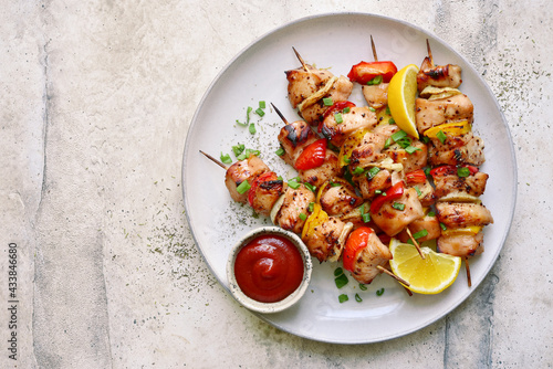Chicken kebab skewers on a plate . Top view with copy space. photo