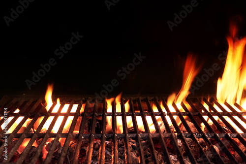 Barbecue Fire Grill Isolated On Black Background. BBQ Flaming Grill Background Isolated. Hot Barbeque Charcoal Cast Iron Grill With Bright Flames.