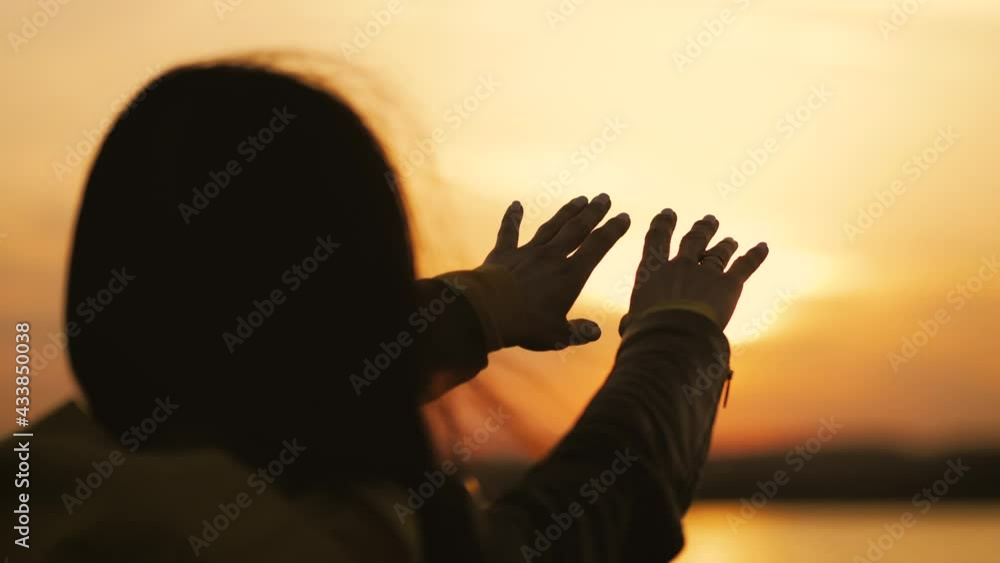 Back view, silhouette lonely woman trying to touch the sun. Young woman looking up into the sky. People, lifestyle, travel and vacations. Stress free concept. Back view, silhouette lonely woman trying to touch the sun. Young woman looking up into the sky. People, lifestyle, travel and vacations. Stress free concept.