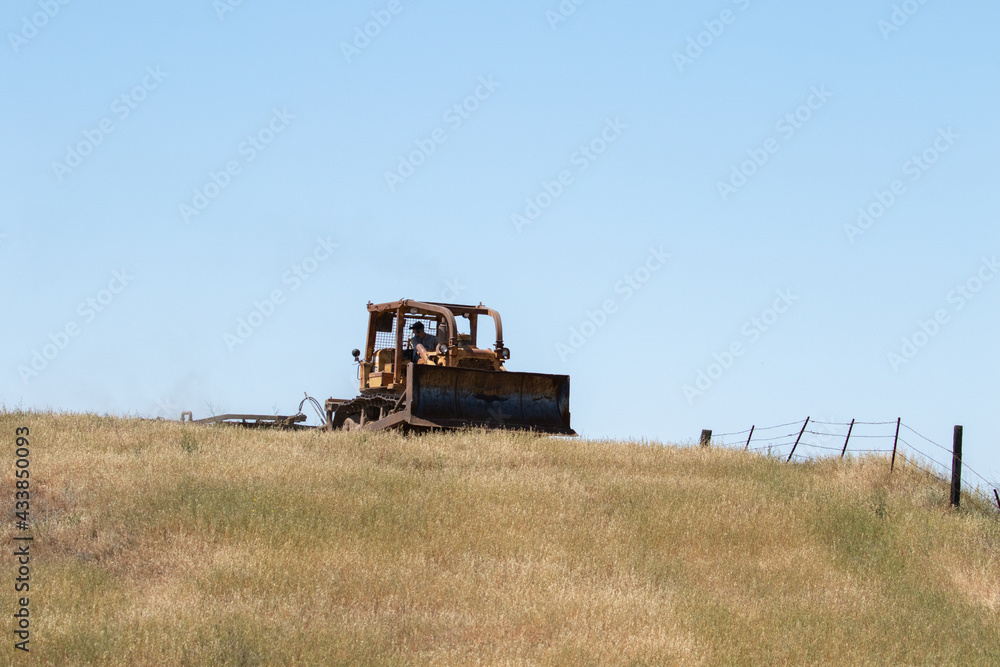 Fototapeta premium Large Bull Dozer in Open Field