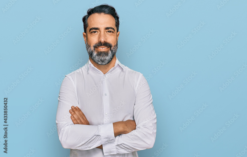 Middle aged man with beard wearing casual white shirt happy face smiling with crossed arms looking at the camera. positive person. Middle aged man with beard wearing casual white shirt happy face smiling with crossed arms looking at the camera. positive person.