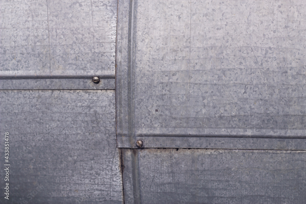 Galvanized iron construction with close up. Grey metallic surface with connected squares. Galvanized iron construction with close up. Grey metallic surface with connected squares.