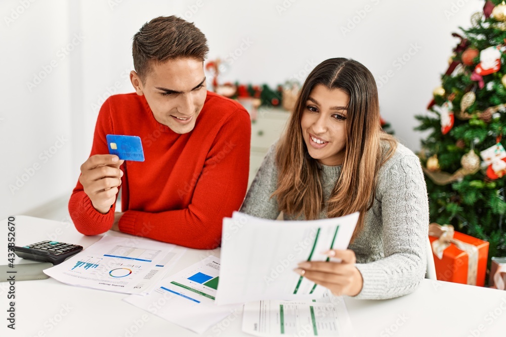 Fototapeta premium Young couple controlling family economy sitting on the table at home.