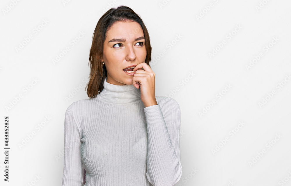 Young caucasian girl wearing casual clothes looking stressed and nervous with hands on mouth biting nails. anxiety problem. Young caucasian girl wearing casual clothes looking stressed and nervous with hands on mouth biting nails. anxiety problem.