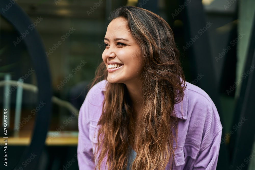 Young hispanic woman smiling happy standing at the city. Young hispanic woman smiling happy standing at the city.