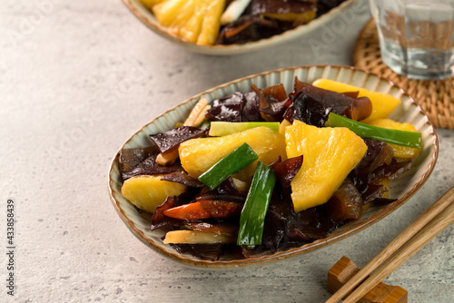 Stir-fried pineapple with black wood ear fungus.