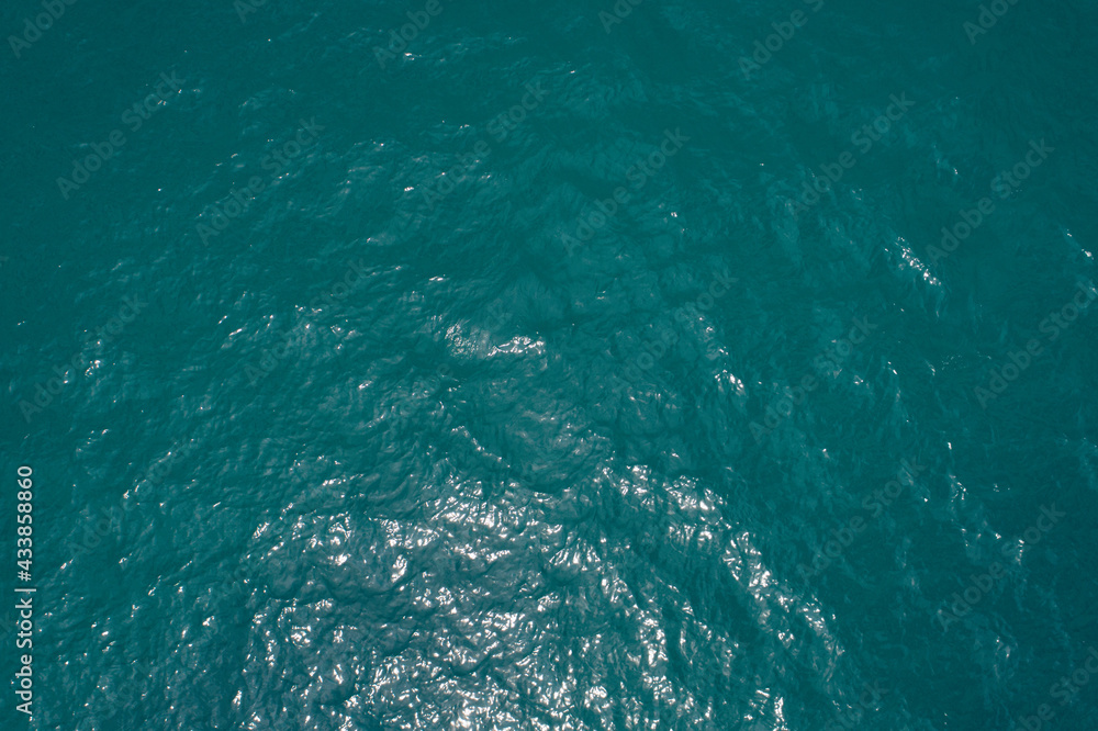 Background image of the tropical sea surface water smooth surface ocean reflection of sun Top view by Drone camera Background image of the tropical sea surface water smooth surface ocean reflection of sun Top view by Drone camera