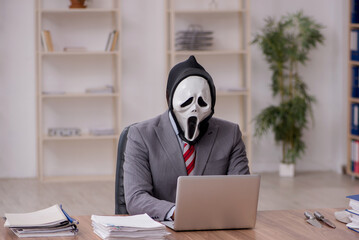 Devil businessman employee sitting at workplace