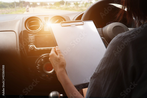 Woman driving car playing phone