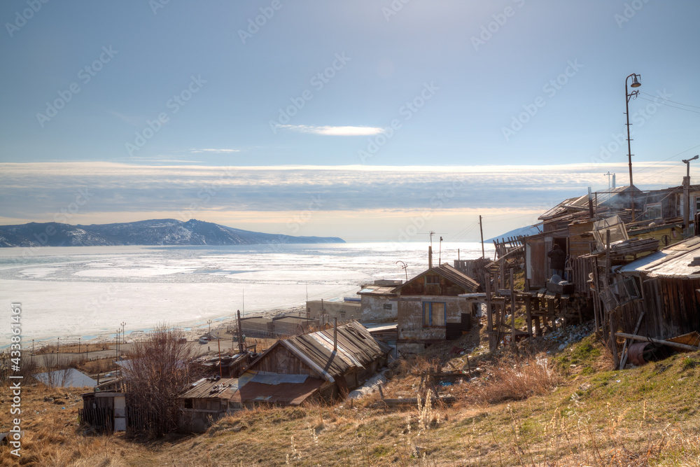 Old houses on the seaside. View of the residential slums and the sea