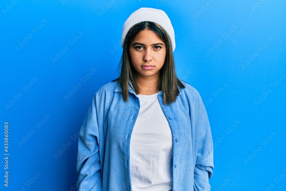 Young latin woman wearing cute wool cap depressed and worry for distress, crying angry and afraid. sad expression. Young latin woman wearing cute wool cap depressed and worry for distress, crying angry and afraid. sad expression.