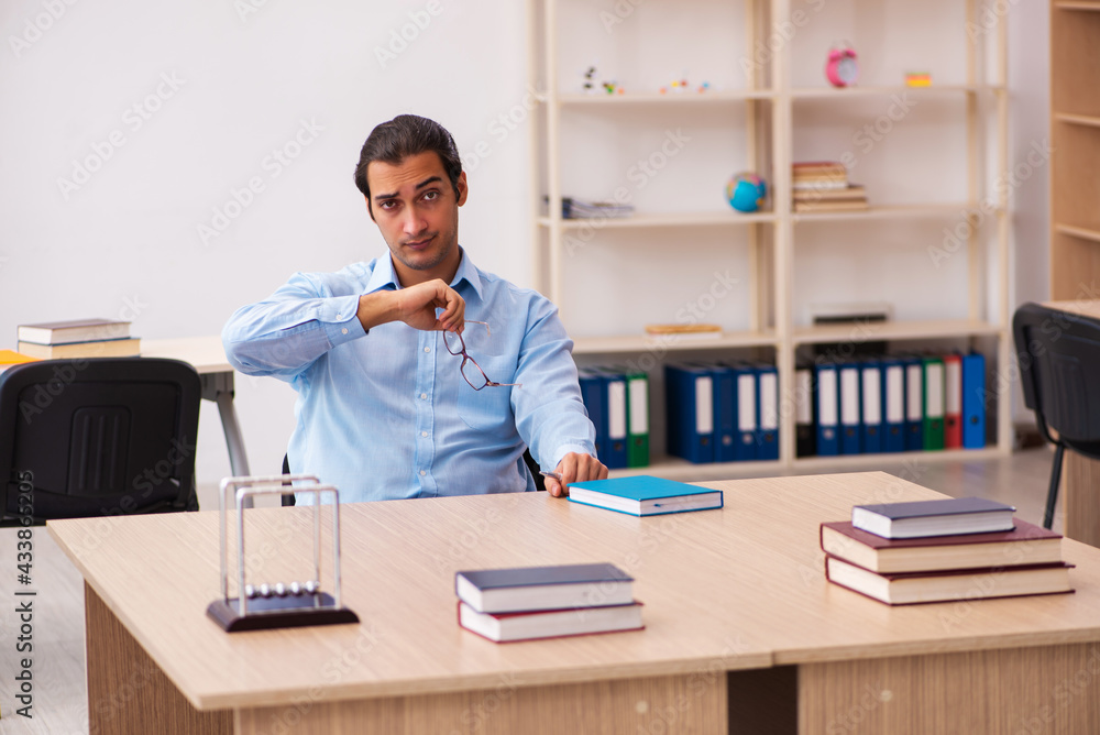 Young male teacher in the classroom Young male teacher in the classroom