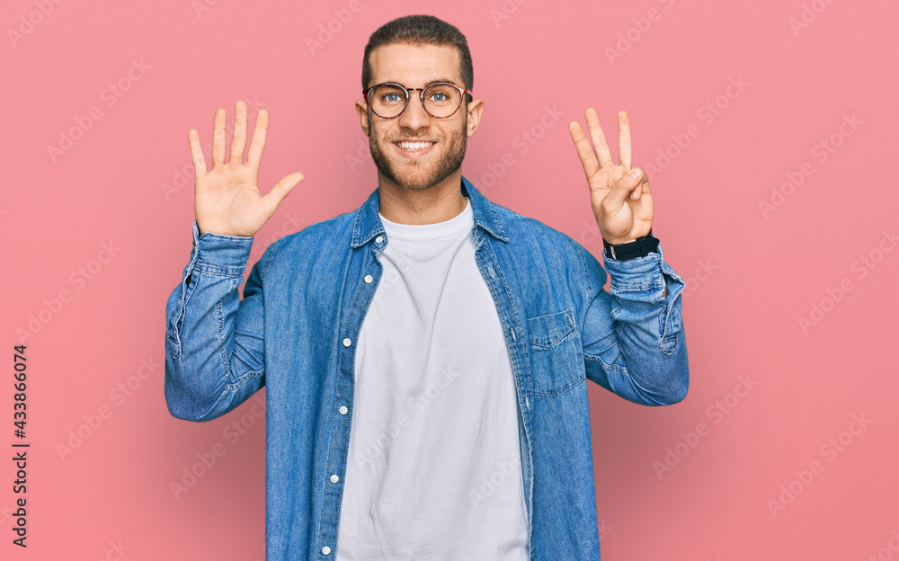 Young caucasian man wearing casual clothes showing and pointing up with fingers number eight while smiling confident and happy. Young caucasian man wearing casual clothes showing and pointing up with fingers number eight while smiling confident and happy.