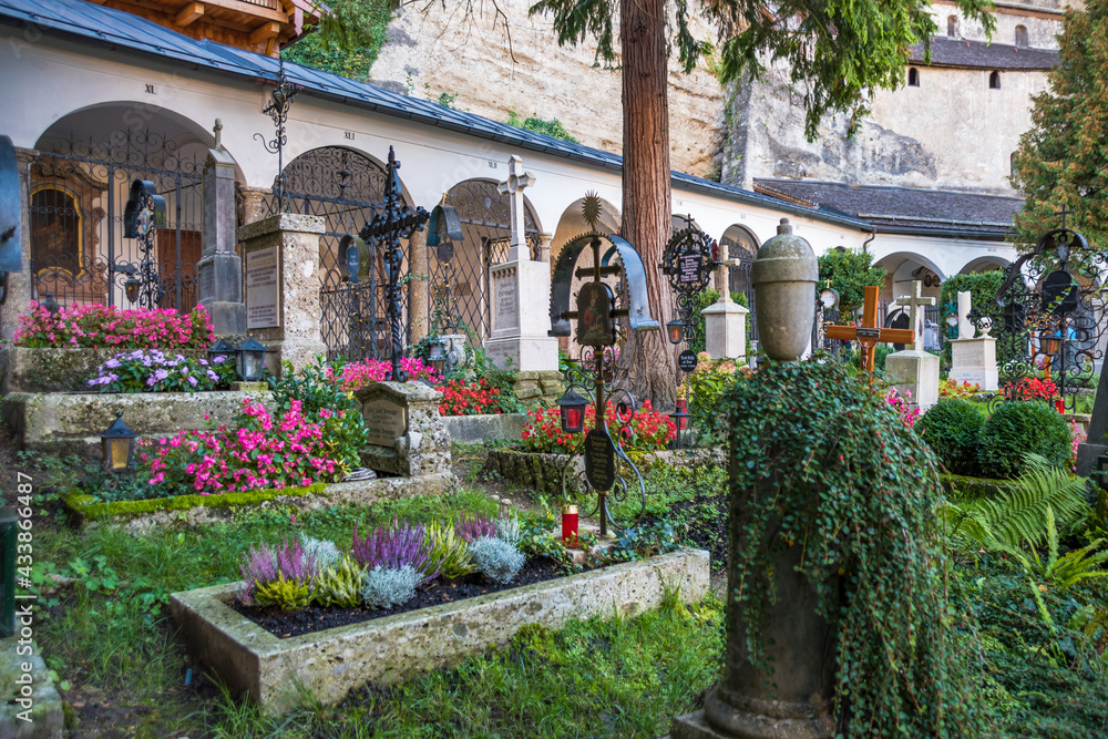 Fototapeta premium Salzburg, Austria, October 2018 - View of some graves at Petersfriedhof (St. Peter's Cemetery) 