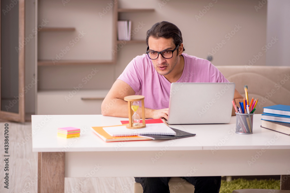 Young male student in time management concept Young male student in time management concept