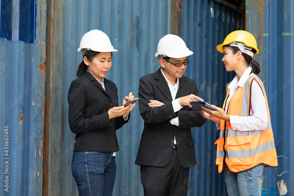 businessman and businesswoman talking with woman engineer in containers warehouse storage businessman and businesswoman talking with woman engineer in containers warehouse storage