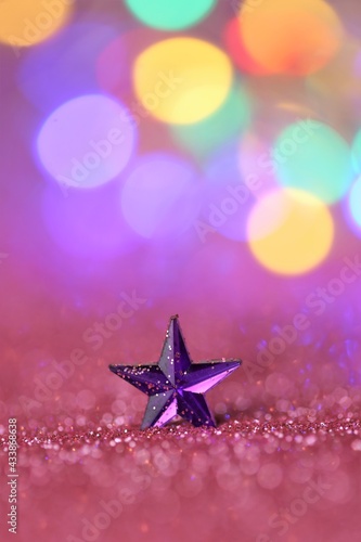 Wallpaper phone.Star in pink glitter with multicolored bokeh on pink background.Festive decorative shining background.Christmas and New Year background.Winter holidays wallpaper