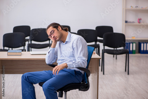 Young male boss giving seminar in the office during pandemic © Elnur