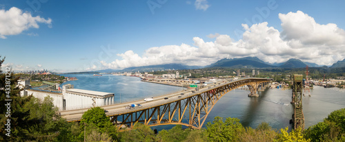 Aerial panoramic view of an Industrial Site and Second Narrows Bridge during a sunny spring day. Taken in Vancouver, British Columbia, Canada. photo