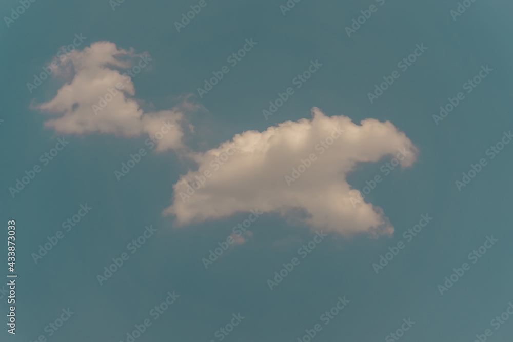 Upward view to cloudscape scene of white fluffy cloud on vivid blue sky Upward view to cloudscape scene of white fluffy cloud on vivid blue sky