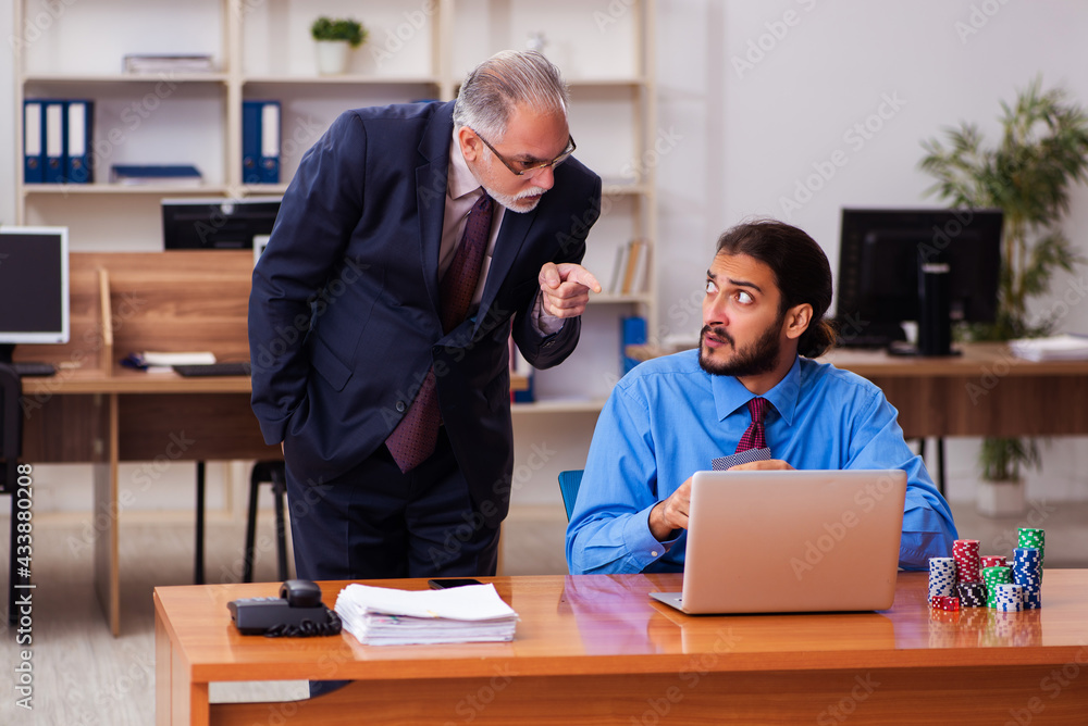 Two male employees in gambling concept Two male employees in gambling concept