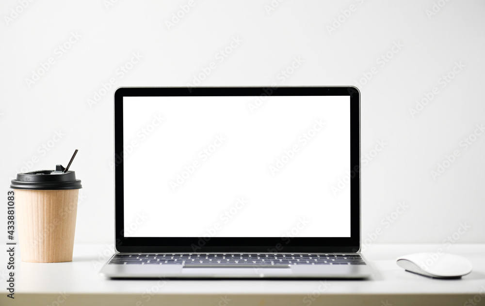 Laptop computer with blank screen in office Laptop computer with blank screen in office