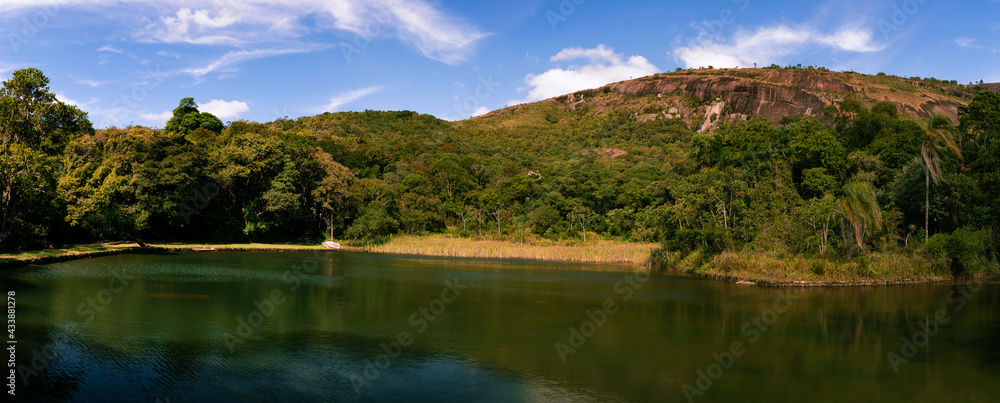 Panorama of natural landscape with lake in the mountain of Big Stone. Water mirror with the location's reflection. Atibaia, Brazil.