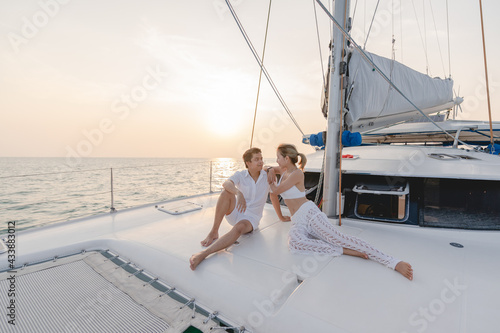 Romantic couple on yacht looking at beautiful sunset.