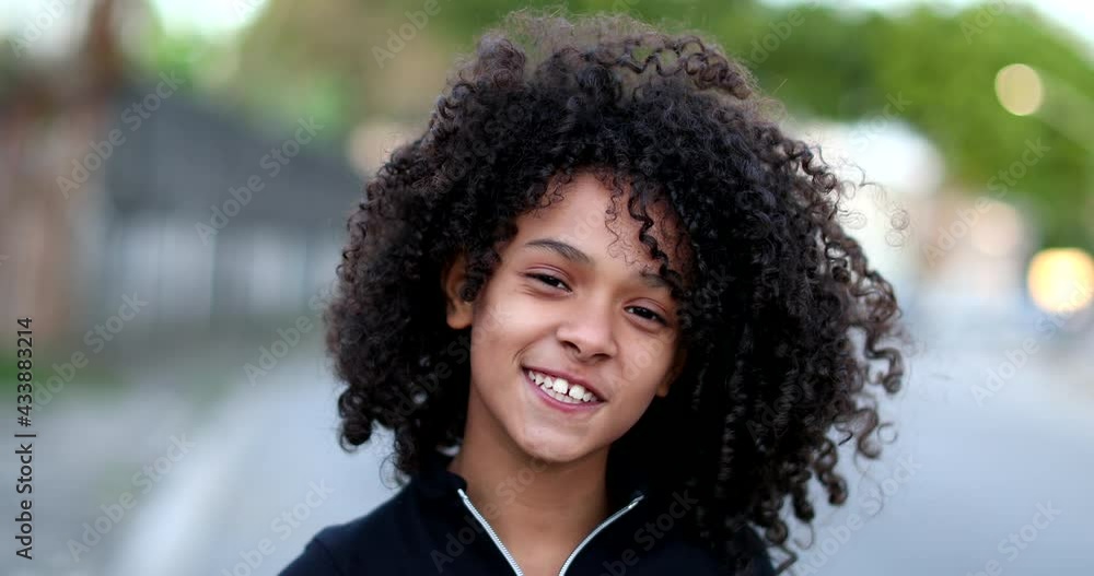 Black preteen girl smiling portrait. Brazilian mixed race child with curly hair face Black preteen girl smiling portrait. Brazilian mixed race child with curly hair face