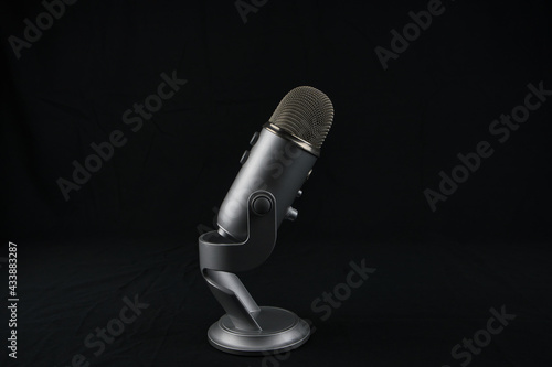 studio microphone for recording podcast on black background