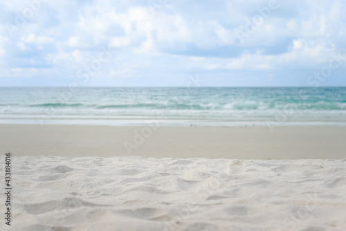 Beautiful sand beach with blurred blue tropical sea background with copy space  summer sunny day on beach  outdoor vacation and travel adventure concept.