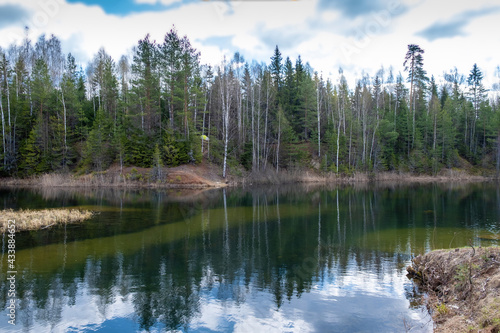 Fototapeta Naklejka Na Ścianę i Meble -  Landscape with a small forest lake on a sunny spring day.