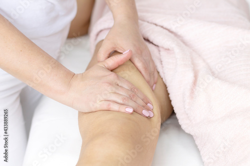 Massage the body  arms  legs  back  abdomen in the massage room with the hands of a specialist with oil with a copy of the space.  The concept of professional body care.