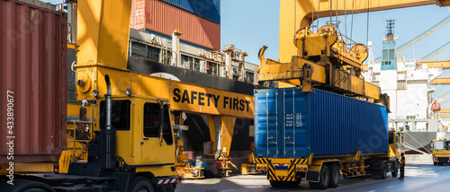 crane loading container box to container cargo freight ship in port shipping containers a logistics business and global trading. logistics, global business and transportation concept