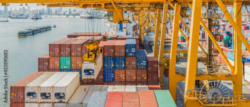 crane loading container box to container cargo freight ship in port shipping containers a logistics business and global trading. logistics, global business and transportation concept