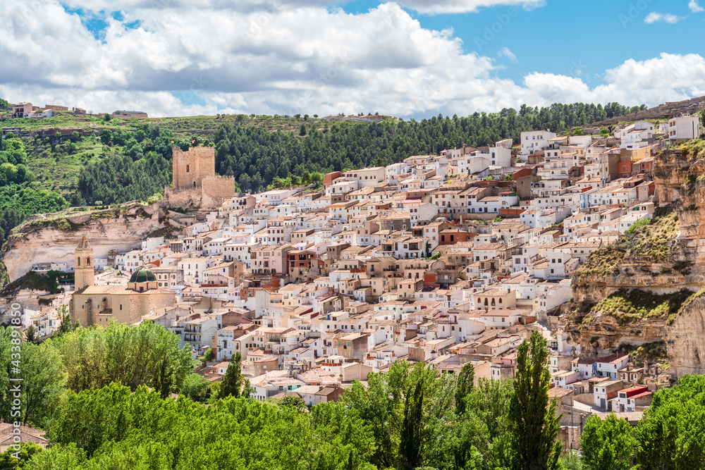 View of Spanish white town with castle and bell tower. Alcala del Jucar, Castilla La Mancha, Spain.
