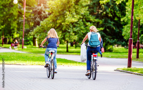 Wallpaper Mural Cyclists ride on the bike path in the city Park
 Torontodigital.ca