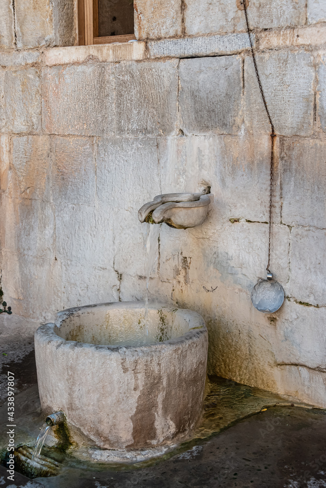 Old stone fountain in Hosios Loukas. Hosios Loukas (Greek: Ὅσιος Λουκᾶς) is a historic walled monastery situated near the town of Distomo, in Boeotia, Greece. 10.08.2019 Old stone fountain in Hosios Loukas. Hosios Loukas (Greek: Ὅσιος Λουκᾶς) is a historic walled monastery situated near the town of Distomo, in Boeotia, Greece. 10.08.2019