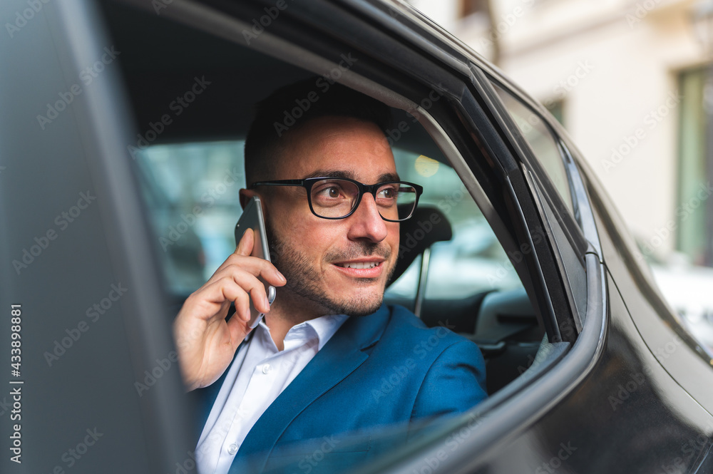Businessman in the Back Seat of a Taxi Having Phone Call. Businessman in the Back Seat of a Taxi Having Phone Call.
