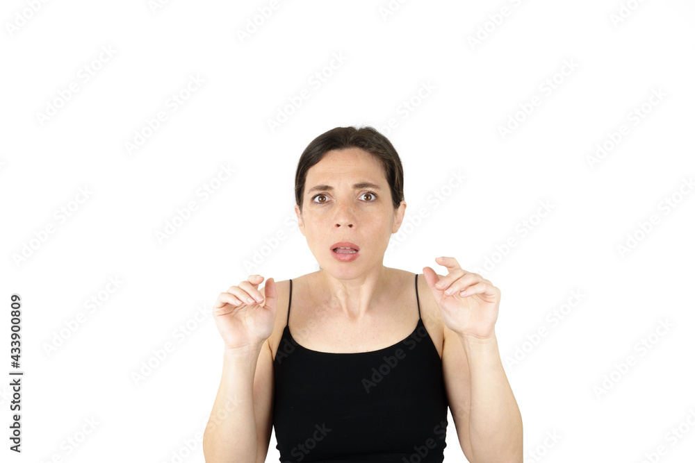 Young beautiful woman pointing up with fingers while thinking at white empty background Young beautiful woman pointing up with fingers while thinking at white empty background