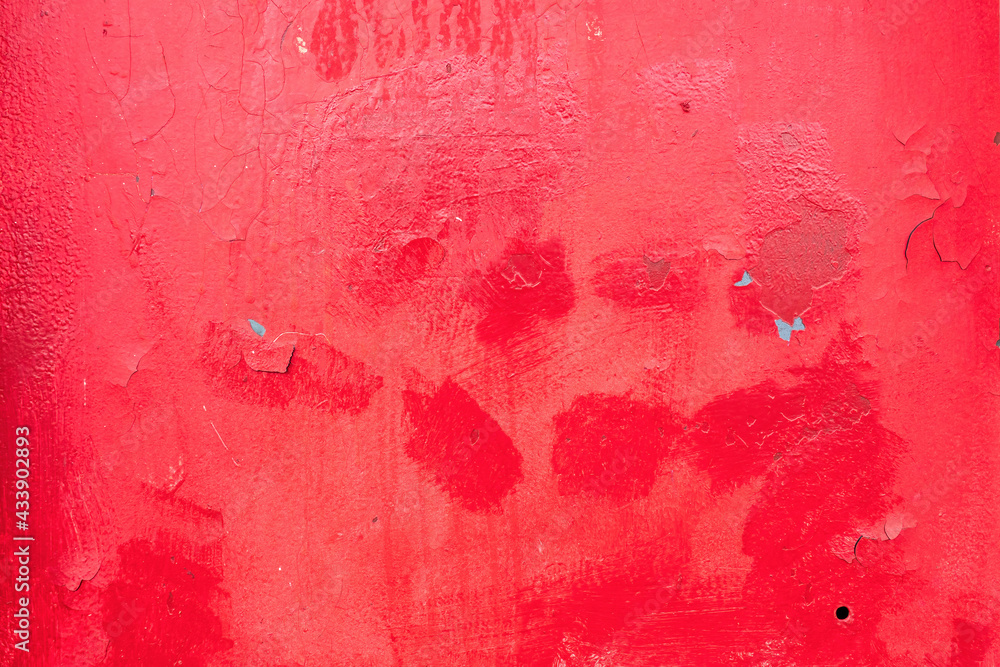 Fototapeta premium The metal sheet is red. The paint is cracked in places, traces of repair and the bottom layer are visible. Background. Texture.