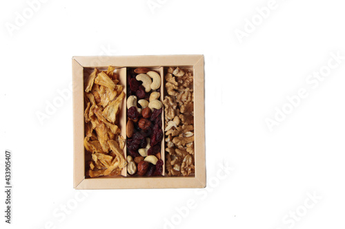 healthy eating food - a box of fruit mix and dried pineapple isolated on white background flat lay