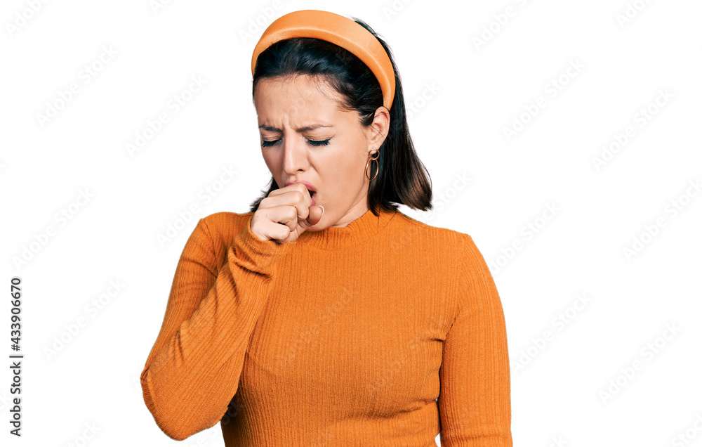 Young hispanic girl wearing casual white t shirt feeling unwell and coughing as symptom for cold or bronchitis. health care concept. Young hispanic girl wearing casual white t shirt feeling unwell and coughing as symptom for cold or bronchitis. health care concept.