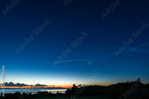 Gorgeous seagull-shaped cloud gliding in the starry sky of a wonderful deep blue just after sunset. Unarizaki park.