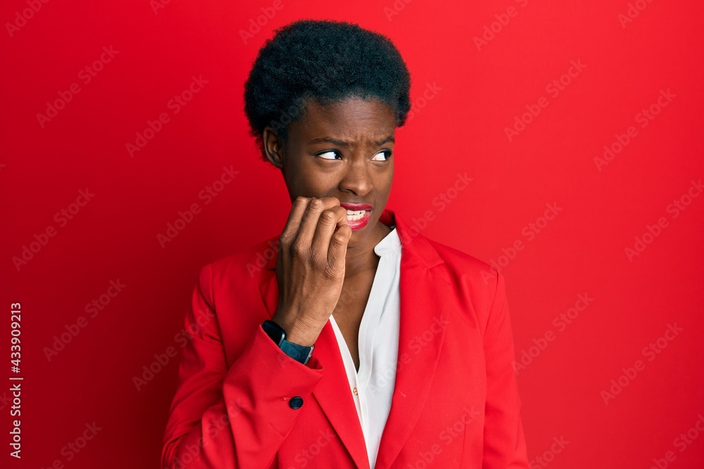 Young african american girl wearing business clothes looking stressed and nervous with hands on mouth biting nails. anxiety problem. Young african american girl wearing business clothes looking stressed and nervous with hands on mouth biting nails. anxiety problem.