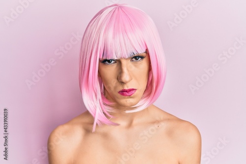 Young man wearing woman make up wearing pink wig depressed and worry for distress, crying angry and afraid. sad expression.