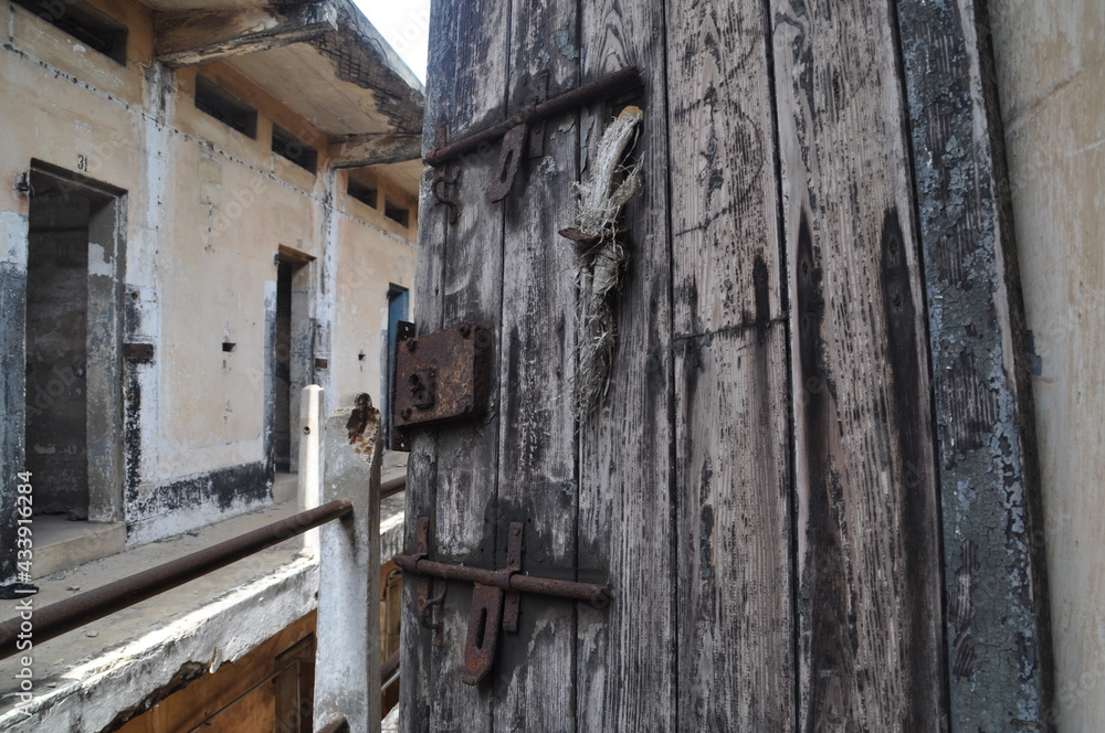 Broken door in an abandoned prison in the former Ussher Fort in Accra, Ghana.